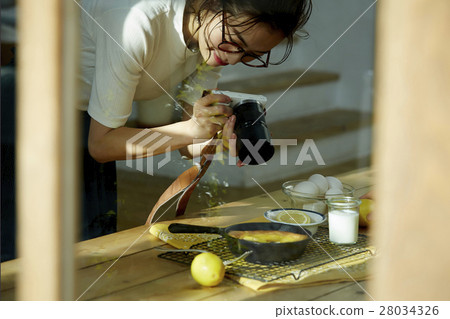 A woman taking home cooking dishes A woman taking home cooking dishes 28034326