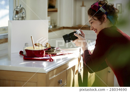 A woman taking home cooking dishes 28034690