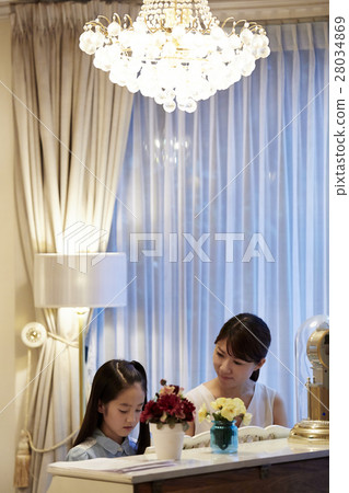 A girl who receives a piano lesson A girl who receives a piano lesson 28034869