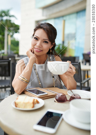 Enjoying cappuccino 28038380