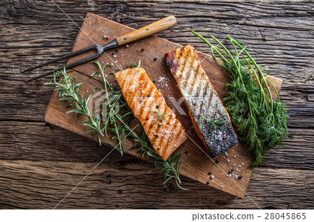 Grilled salmon, sesame seeds and herb decoration.  28045865
