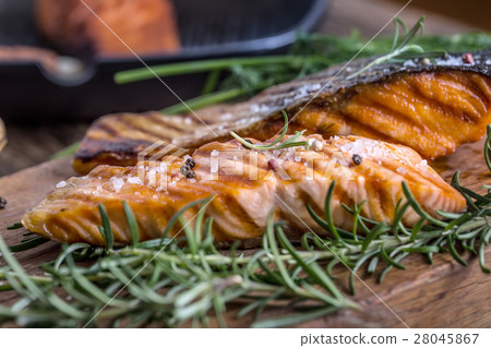 Grilled salmon, sesame seeds and herb decoration. Grilled salmon, sesame seeds and herb decoration. 28045867