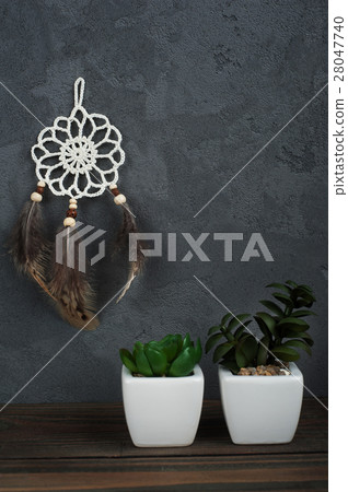 Small dream catcher on concrete background 28047740