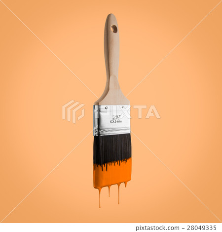 Paintbrush loaded with orange color dripping. 28049335