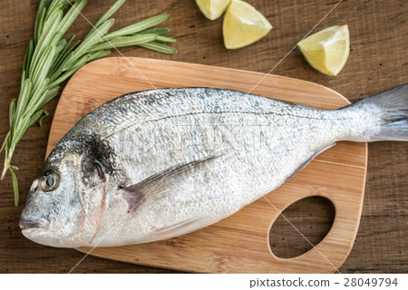 Fresh dorada with ingredients on the wooden board 28049794