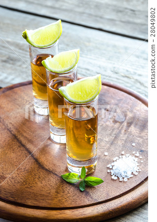 Glasses of tequila on the wooden board 28049802