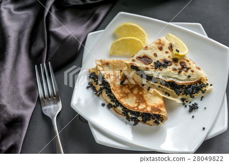 Crepes with black caviar 28049822