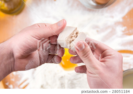 Man spiting yeast in dough making 28051184