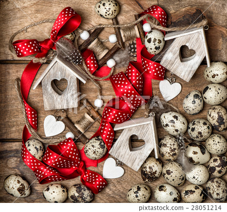 Easter decorations quail eggs and red ribbon bow 28051214