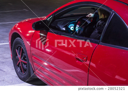 young driver sitting in red sport car young driver sitting in red sport car 28052321