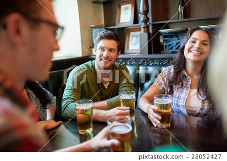 happy friends drinking beer at bar or pub happy friends drinking beer at bar or pub 28052427