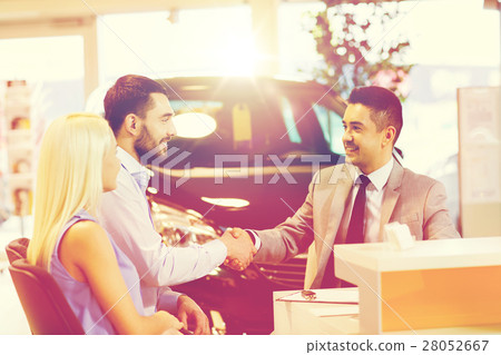 happy couple with car dealer in auto show or salon happy couple with car dealer in auto show or salon 28052667