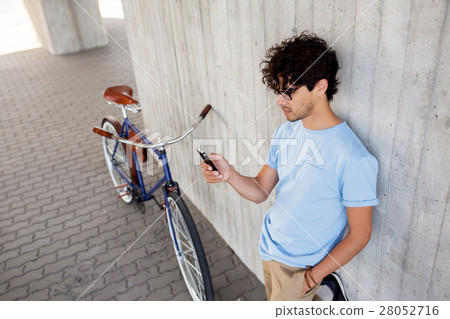 man with smartphone and fixed gear bike on street man with smartphone and fixed gear bike on street 28052716