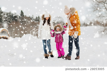 happy family in winter clothes walking outdoors 28053005