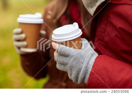close up of couple hands with coffee in autumn 28053098