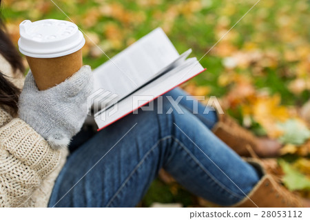 woman with book drinking coffee in autumn park woman with book drinking coffee in autumn park 28053112