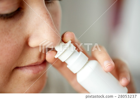 close up of sick woman using nasal spray 28053237
