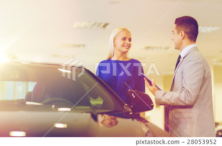 happy woman with car dealer in auto show or salon 28053952