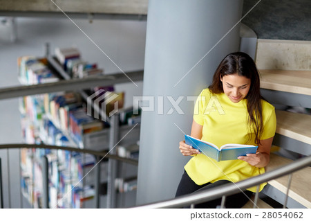 high school student girl reading book at library 28054062