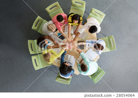 group of international students with hands on top 28054064