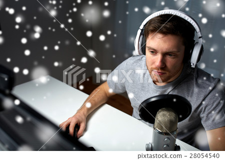 man in headset playing computer video game at home man in headset playing computer video game at home 28054540