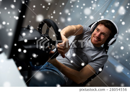 man playing car racing video game at home man playing car racing video game at home 28054556