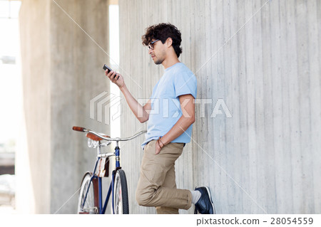 man with smartphone and fixed gear bike on street 28054559