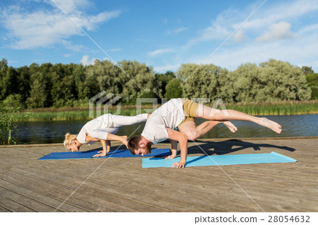 people making yoga exercises outdoors people making yoga exercises outdoors 28054632