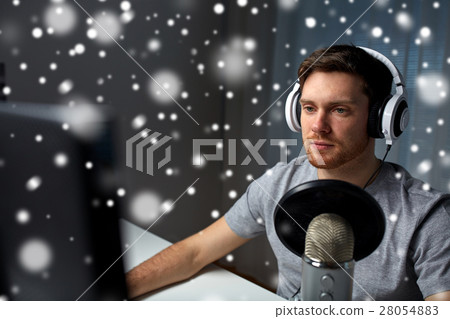 man in headset playing computer video game at home man in headset playing computer video game at home 28054883