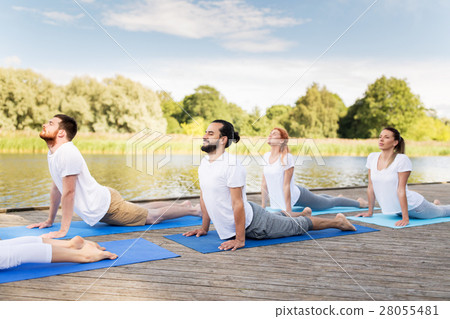 group of people making yoga exercises outdoors 28055481