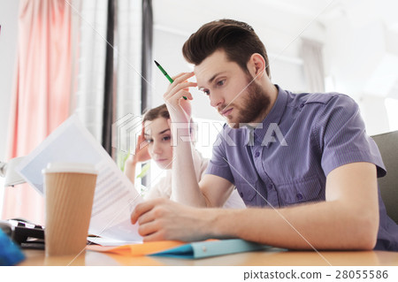 creative team with computer and papers in office 28055586