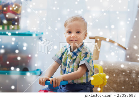 happy little baby boy driving ride-on car at home happy little baby boy driving ride-on car at home 28055698