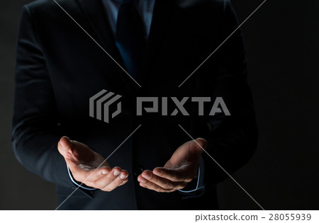 close up of businessman holding something in hands 28055939