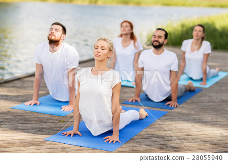 group of people making yoga exercises outdoors 28055940