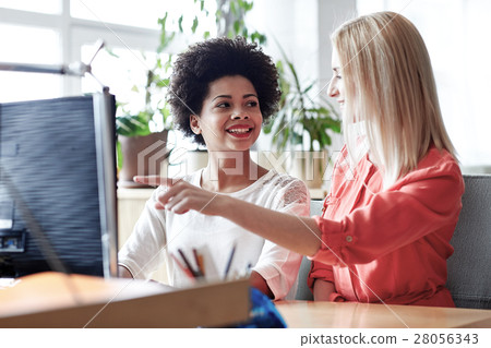 happy women or students with computer in office happy women or students with computer in office 28056343