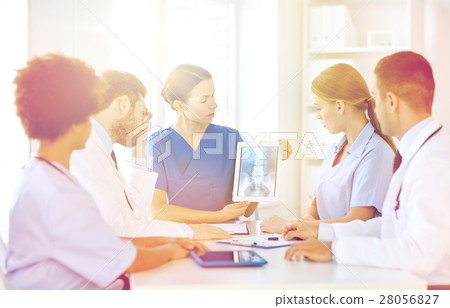 group of doctors with x-ray on tablet pc at clinic group of doctors with x-ray on tablet pc at clinic 28056827