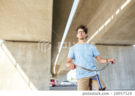 young hipster man riding fixed gear bike young hipster man riding fixed gear bike 28057129