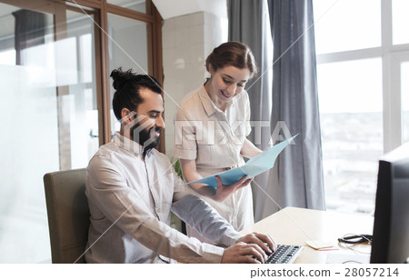 happy creative team with computer in office happy creative team with computer in office 28057214