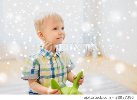 happy baby boy playing with ride-on toy at home happy baby boy playing with ride-on toy at home 28057396