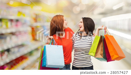 teenage girls with shopping bags and credit card 28057427