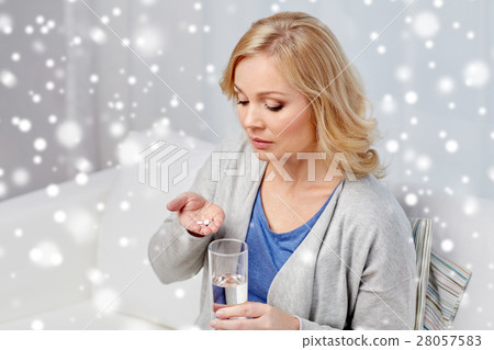 woman with medicine and water glass at home woman with medicine and water glass at home 28057583