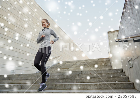 happy sporty woman running downstairs in city happy sporty woman running downstairs in city 28057585