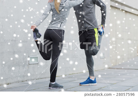 close up of couple stretching legs outdoors 28057596