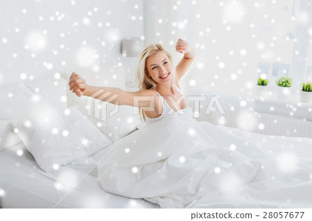 young woman stretching in bed at home bedroom young woman stretching in bed at home bedroom 28057677