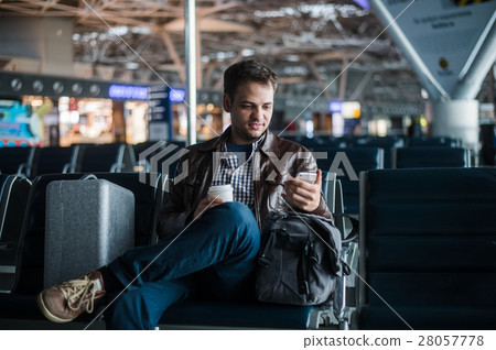 Handsome smiling man in casual wear holding Handsome smiling man in casual wear holding 28057778