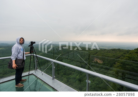 Young man with taking a photo on the top of 28057898