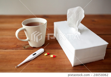 cup of tea, paper wipes and thermometer with pills cup of tea, paper wipes and thermometer with pills 28058062