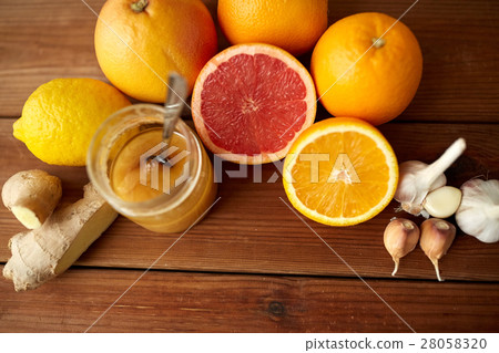 honey, citrus fruits, ginger and garlic on wood honey, citrus fruits, ginger and garlic on wood 28058320