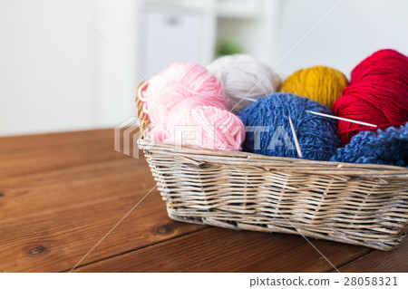 basket with knitting needles and balls of yarn basket with knitting needles and balls of yarn 28058321