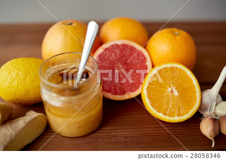 honey, citrus fruits, ginger and garlic on wood honey, citrus fruits, ginger and garlic on wood 28058346
